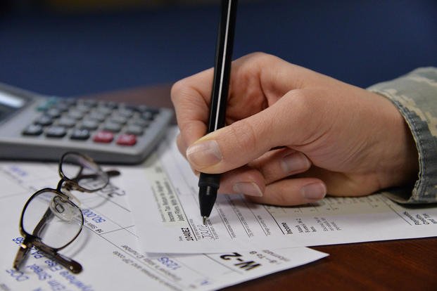 An Airman fills out tax forms, Feb. 9, 2017, at Malmstrom Air Force Base, Mont. (U.S. Air Force photo/Daniel Brosam)